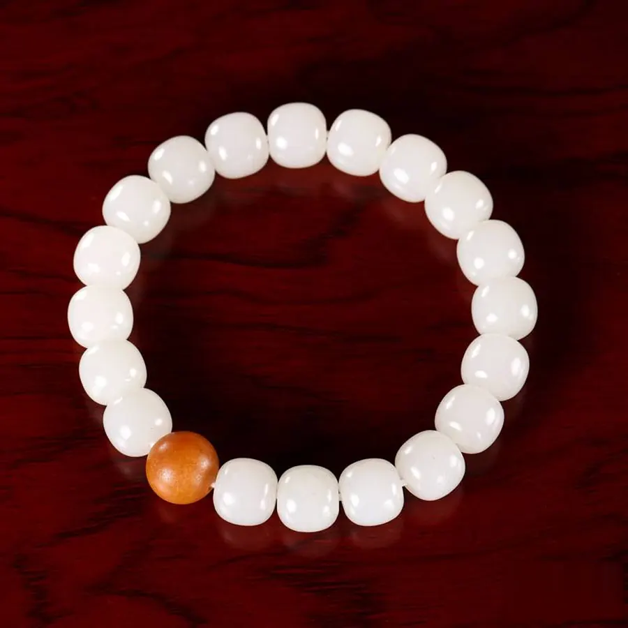 White Hetian jade barrel bead bracelet with a warm-coloured accent bead